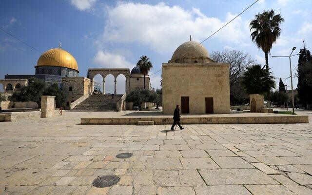 A man walks past the Dome of the Rock, in the Temple Mount compound, in the Old City of Jerusalem on March 16, 2020. (Emmanuel DUNAND/AFP)