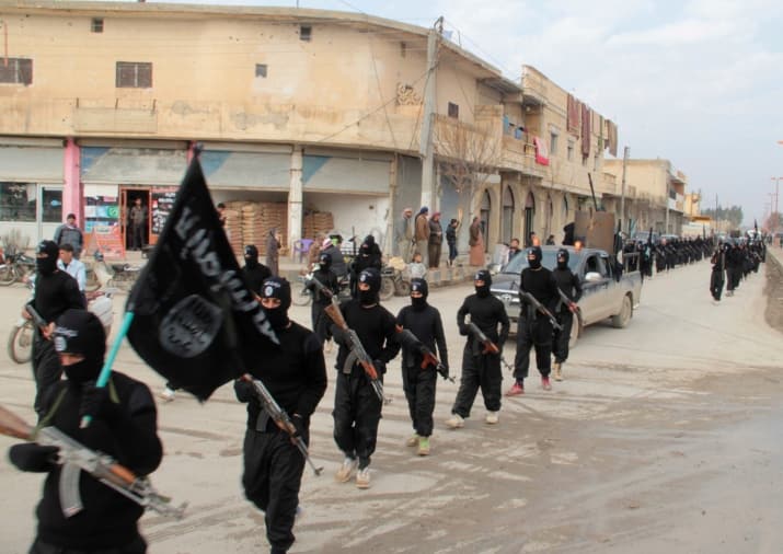 ISIS militants march in Syria in 2014.