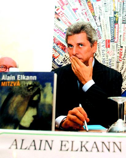 Alain Ellkann with "Mitzva" book.